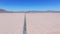 Endless road to horizon through the desert valley. Aerial view of a desert.