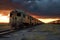 endless rows of abandoned trains under dramatic sky