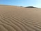 Endless sand dunes under blue sky