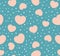 Endless seamless pattern of hearts of different sizes. Beige vector hearts on turquoise. Wallpaper for wrapping paper.