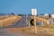 Endless straight road through dry farmland in Australian Outback