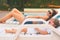 Endless summer Cute baby and mother relaxing at sunbed