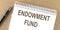 ENDOWMENT FUND text on a notepad with pen, business concept