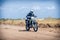 Enduro bike racer driving on dirt motocross dust track