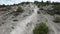 Enduro motorcycles climbing a mountain of fine white sand