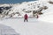 ENEES, ANDORRA - FEBRUARY 14, 2019: Skiers in red suits descend a gentle slope for beginners in the picturesque