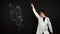 Energetic doctor dances next to blackboard where digestive system is painted