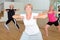 Energetic elderly woman practicing vigorous dance movements