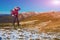 Energetic Female Hiker Staying on Snowy Terrain and Observing Scenic Mountain View