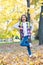 Energetic little kid carry backpack running to school in autumn park outdoors, September 1