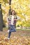 Energetic little kid carry backpack running to school in autumn park outdoors, September 1