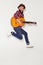 Energetic man jumping with guitar