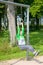 Energetic middle-aged woman working out on rings in a park