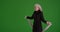 Energetic senior woman dancing on greenscreen