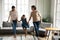 Energetic three generations of women dancing at home