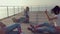 Energetic twerk by trendy teen girls on a wooden pier near the sea