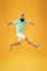 Energetic and upbeat music for leisure. Energetic hipster jumping high on yellow background. Bearded man in mid air