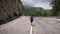 Energetic woman running on mountain road. Determined female running and achieving sports fitness goals. Fitness activity and recre