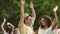 Energetic young people waving hands, dancing to music at talent show audition