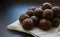 Energy balls on baked wax paper on a black background. Handmade raw vegan product. no bake