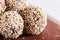 Energy balls cakes with almonds, sesame, cashew, walnuts, dates and germinated wheat, side view, close up