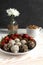 energy balls or prothin balls, healthy sweets on a flat plate with strawberries and dalgona coffee