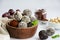 Energy balls. Truffles of dates, walnuts, hazelnuts and cocoa in a wooden bowl on a light background. Healthy dessert, sugar-free