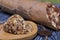 An energy bar made of dried fruits, nuts and seeds. Wrapped in edible paper. The wax seal is visible. On black pine boards