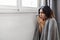 Energy Crisis. Freezing Arab Woman Sitting Near Cold Radiator At Home