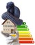 Energy efficiency label for house / heating and money savings - model of a house with cap in a hand in gloves