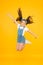 Energy inside. Small girl jump yellow background. Enjoy freedom. Childrens day concept. Spirit of freedom. Active girl