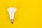 Energy saving wifi light bulb on yellow background.