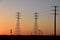 Energy towers with orange sunset background.