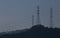 Energy towers during sunset with a vibrant white reflection at the poles on a peaceful blue background, Braga.