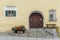 Engadin house architectural detail with cobblestone street and flowers and bench