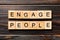 ENGAGE PEOPLE word written on wood block. ENGAGE PEOPLE text on wooden table for your desing, concept