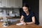 Engaged happy millennial college student girl writing notes at laptop