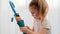 Engaged little girl with pigtails examines colorful umbrella