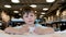 Engaged young boy with brown hair examines white paper piece