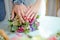 Engagement flowers .The girl and the boy put their hands on colorfull roses. Bride and groom with Engagement gold rings put their