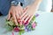 Engagement flowers .The girl and the boy put their hands on colorfull roses. Bride and groom with Engagement gold rings put their