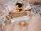 Engagement ring and a perfume, gold, white and pink, wedding details, bridal morning