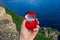 Engagement ring in a red velvet box for a marriage proposal while traveling around Europe and the world - in Italy on Lake Como