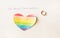 Engagement ring on a white background and the inscription I love women, heart in the form of a LGBT flag, lesbian