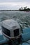 An engine at the back of a boat on a sea in Tonga