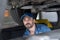 An engine mechanic inspecting the car in Auto Car Service. Car mechanics repairing in a car on hydraulic lift