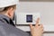 Engineer adjusting thermostat for efficient automated heating system