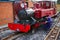 Engineer applying oil lubricant to a vintage steam train