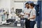 Engineer And Apprentice Meet On Floor Of Engineering Workshop