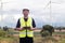 Engineer asian man  holding laptop tablet with wind turbine